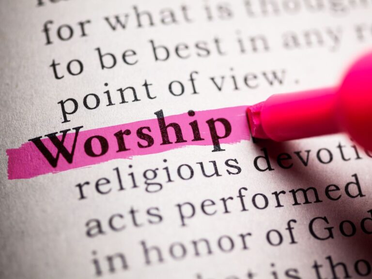 The word worship highlighted in a book