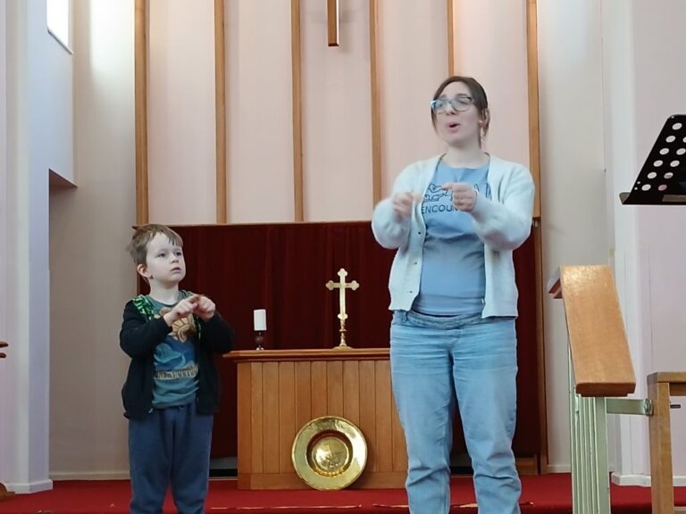 And adult and a child leading an action song.