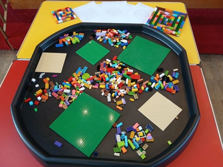A tuff tray with lego bricks and baseboards.