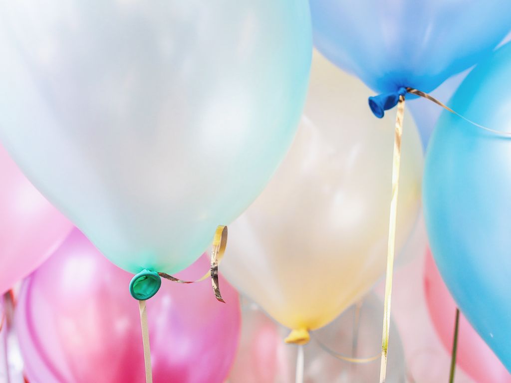 A bunch of pastel coloured helium balloons.
